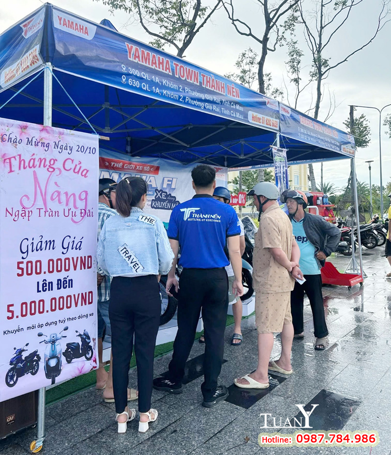 Trang trí thêm Standee dựng cạnh nhà bạt cũng là cách giới thiệu sự kiện đến khách hàng